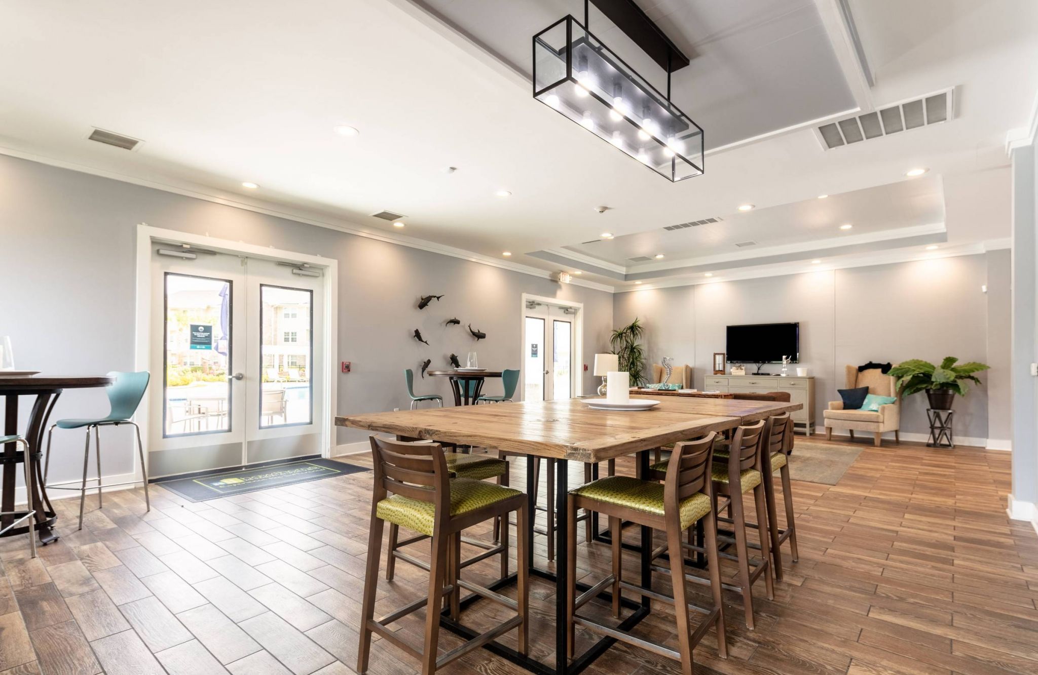 Elegant communal dining and social space with chic lighting and a blend of modern and rustic decor at Hawthorne at Hawthorne at Stillwater